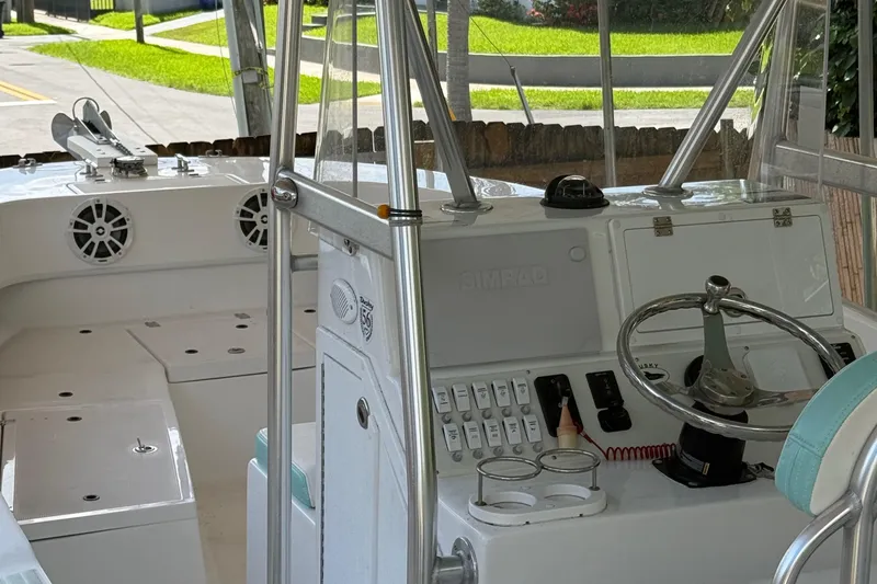 Slide: The Image of Interior view of 2023 Dusky 252 boat, featuring steering wheel and control panel. - 14