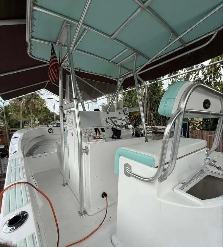 Slide: The Image of 2023 Dusky 252 boat interior with mint green accents and steering console. - 6