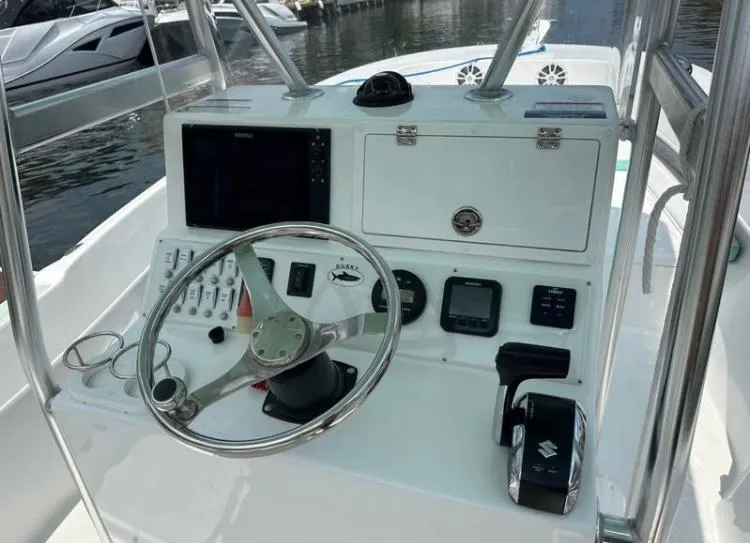 Slide: The Image of Control panel of 2023 Dusky 252 boat with steering wheel and navigation equipment. - 7