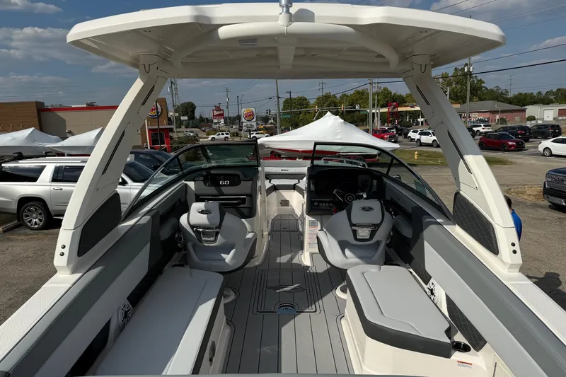 Slide: The Image of 2025 Chaparral 2870 SSX boat interior with seating and helm, parked outdoors. - 15