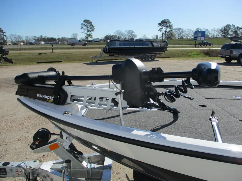 Slide: The Image of 2025 Vexus AVX 1980 boat with Minn Kota trolling motor in a parking area. - 12