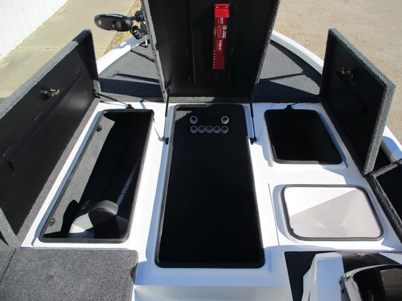 Slide: The Image of 2025 Vexus AVX 1980 boat interior with open storage compartments and fishing rod holders. - 8
