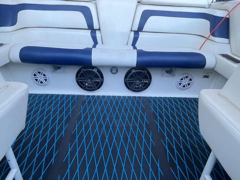 Slide: The Image of Interior of 1998 Fountain 38 Fever boat with blue and white seating and speakers. - 8