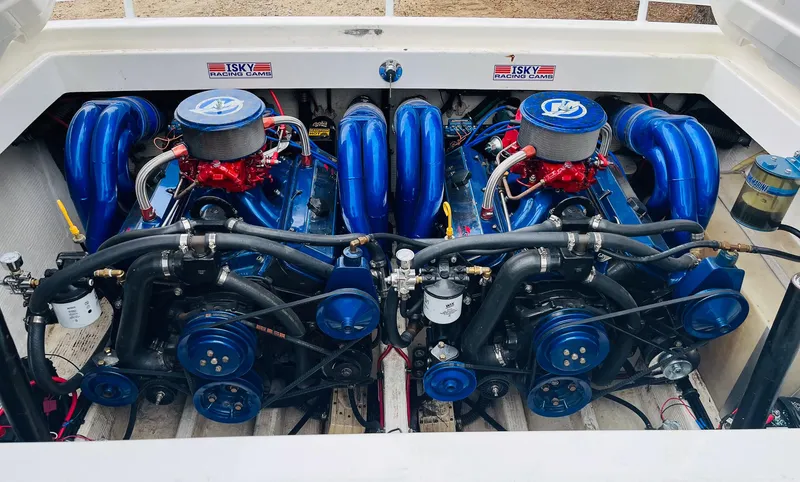 Slide: The Image of Twin engines of a 1998 Fountain 38 Fever boat, showcasing detailed mechanics. - 9