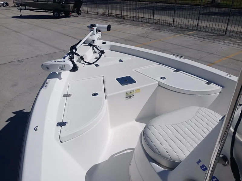 Slide: The Image of 2010 NauticStar 1810 boat deck with seating and storage compartments. - 7