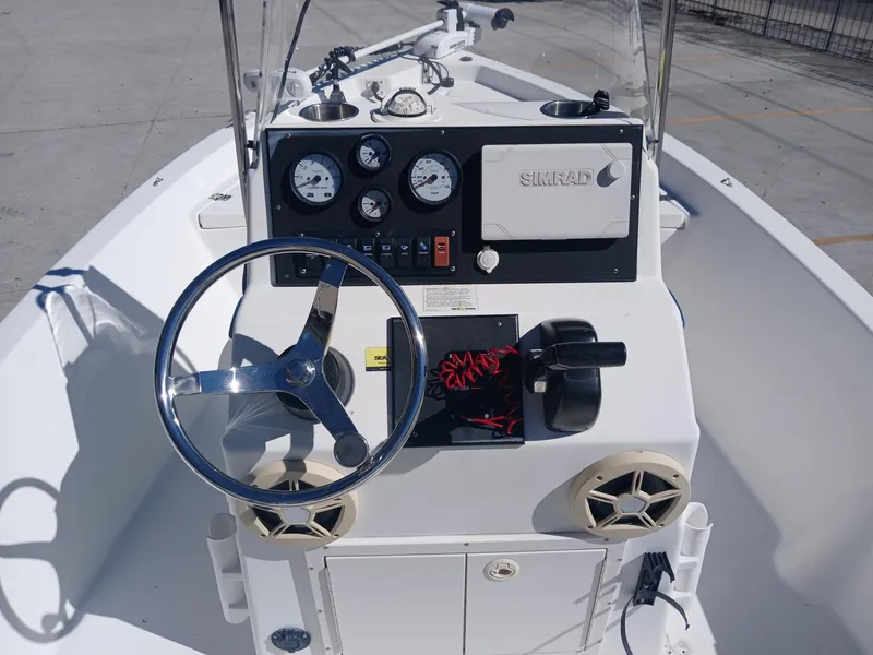 Slide: The Image of Center console of a 2010 NauticStar 1810 boat with steering wheel and gauges. - 8