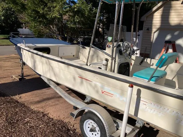 The Image of 1997 Carolina Skiff 198 DLV boat on trailer, parked outdoors. - 0