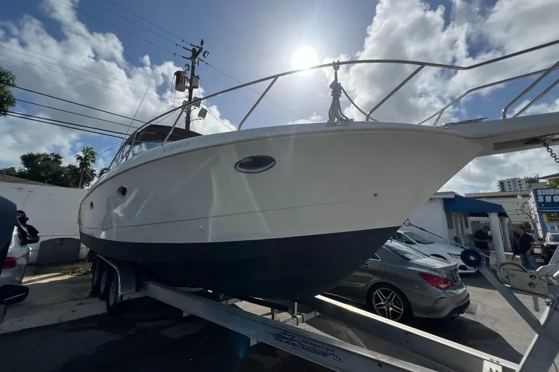 The Image of 1996 Silverton 310 Express boat on trailer under sunny sky. - 0