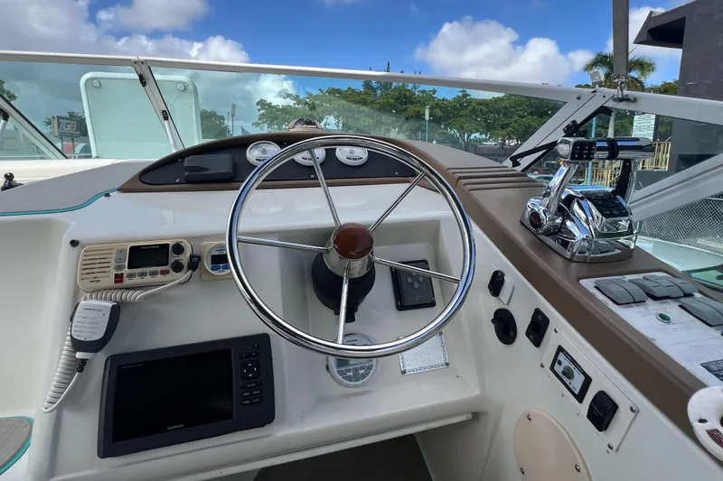 Slide: The Image of 1996 Silverton 310 Express boat helm with steering wheel, gauges, and navigation equipment. - 10
