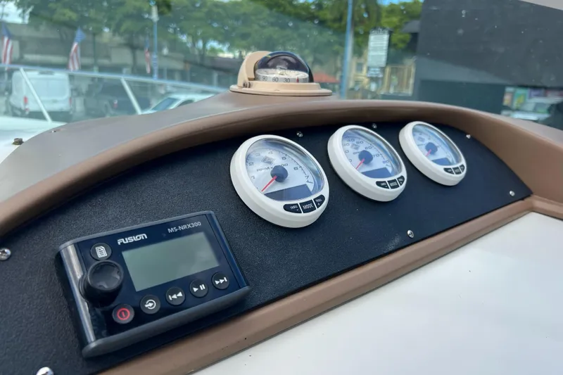 Slide: The Image of Dashboard of a 1996 Silverton 310 Express boat with gauges and a Fusion stereo. - 11