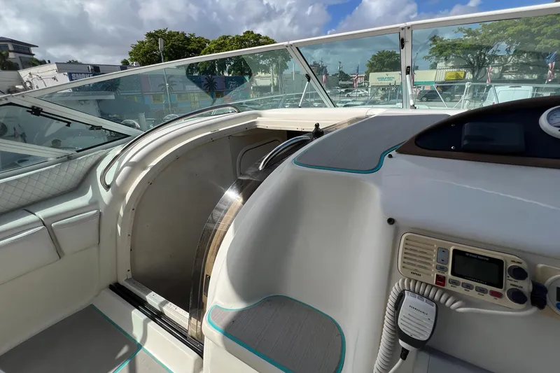 Slide: The Image of 1996 Silverton 310 Express boat cockpit with control panel and seating area. - 13