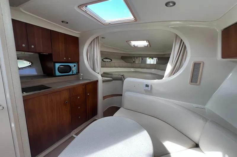 Slide: The Image of Interior of 1996 Silverton 310 Express boat with kitchenette and seating area. - 14