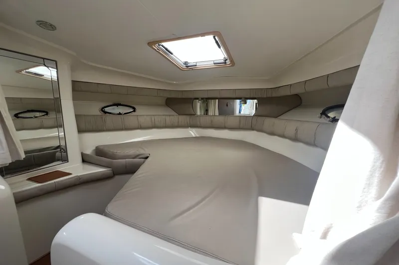 Slide: The Image of 1996 Silverton 310 Express cabin interior with skylight and cushioned seating. - 19
