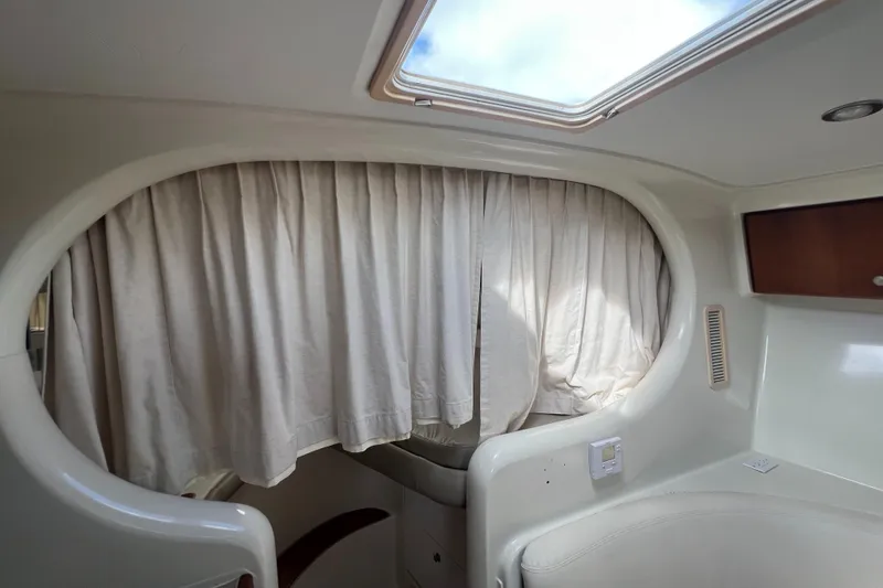 Slide: The Image of Interior cabin of 1996 Silverton 310 Express boat with curtains and skylight. - 21