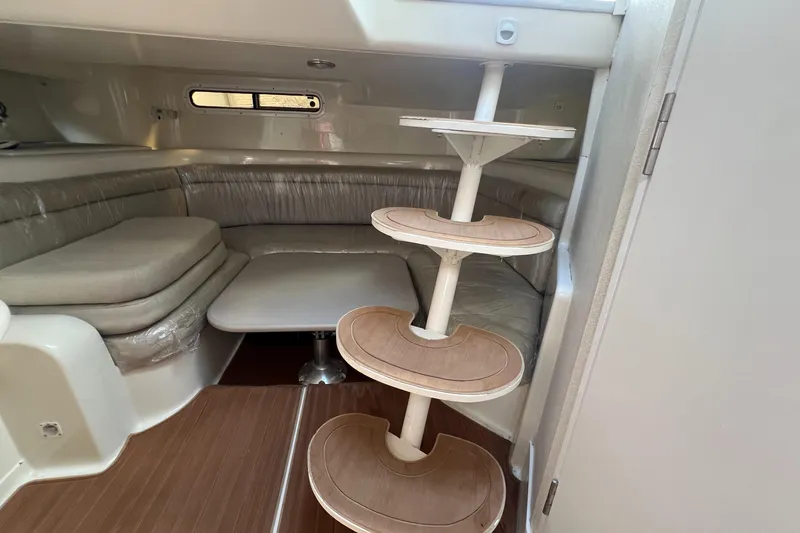 Slide: The Image of 1996 Silverton 310 Express cabin interior with seating and spiral staircase. - 23