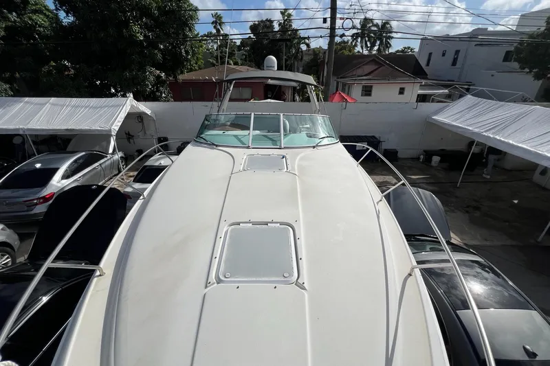 Slide: The Image of 1996 Silverton 310 Express boat, docked with surrounding cars and tents. - 28
