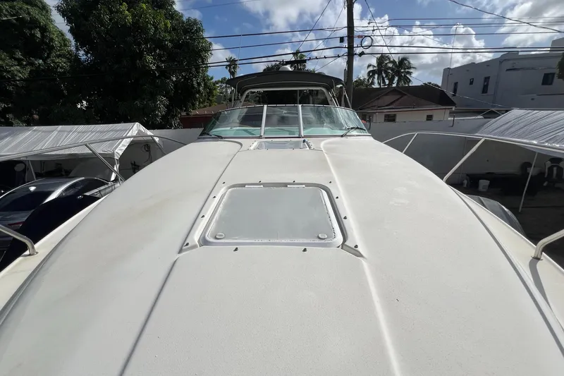 Slide: The Image of 1996 Silverton 310 Express boat, docked outdoors under a clear sky. - 29