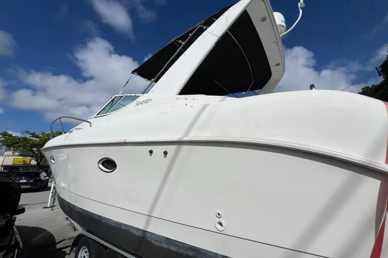 Slide: The Image of 1996 Silverton 310 Express boat with white hull under a blue sky. - 3