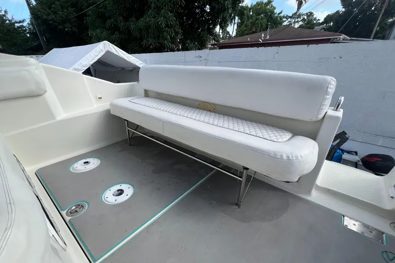 Slide: The Image of 1996 Silverton 310 Express boat with white seating and deck view. - 33