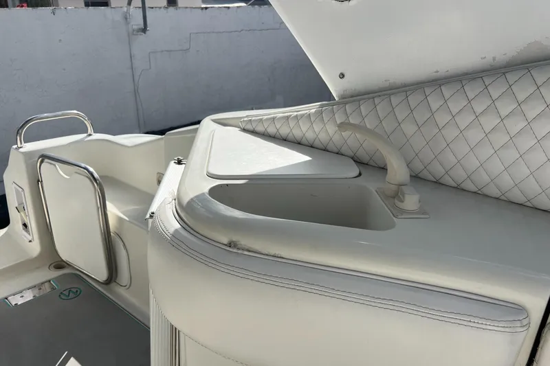 Slide: The Image of 1996 Silverton 310 Express boat interior with sink and quilted upholstery. - 34
