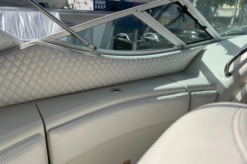 Slide: The Image of Interior of 1996 Silverton 310 Express boat with quilted upholstery and open window. - 35