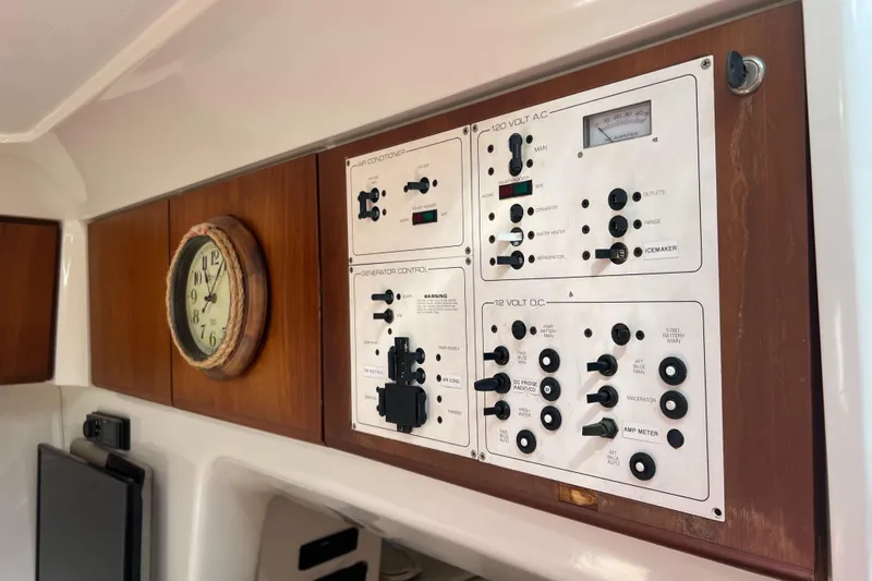 Slide: The Image of Control panel and clock inside a 1996 Silverton 310 Express boat. - 37