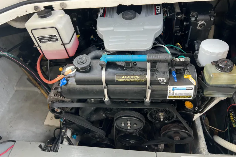 Slide: The Image of Engine compartment of a 1996 Silverton 310 Express boat, showcasing various components. - 39