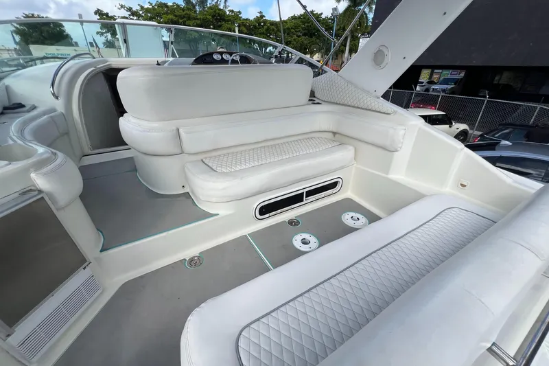 Slide: The Image of 1996 Silverton 310 Express boat interior with white seating and modern design. - 4
