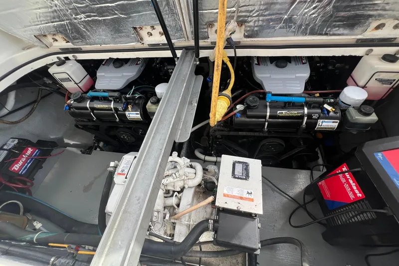 Slide: The Image of Engine compartment of a 1996 Silverton 310 Express boat, showcasing dual engines and equipment. - 40
