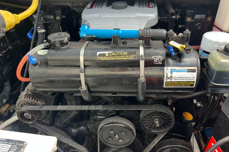 Slide: The Image of Engine compartment of a 1996 Silverton 310 Express boat, showcasing belts and components. - 41