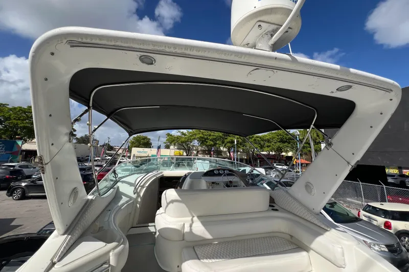 Slide: The Image of 1996 Silverton 310 Express boat with canopy, featuring spacious seating and modern design. - 42