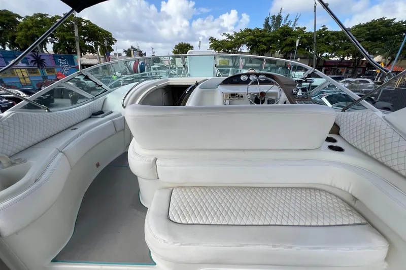 Slide: The Image of 1996 Silverton 310 Express boat interior with white seating and dashboard. - 6