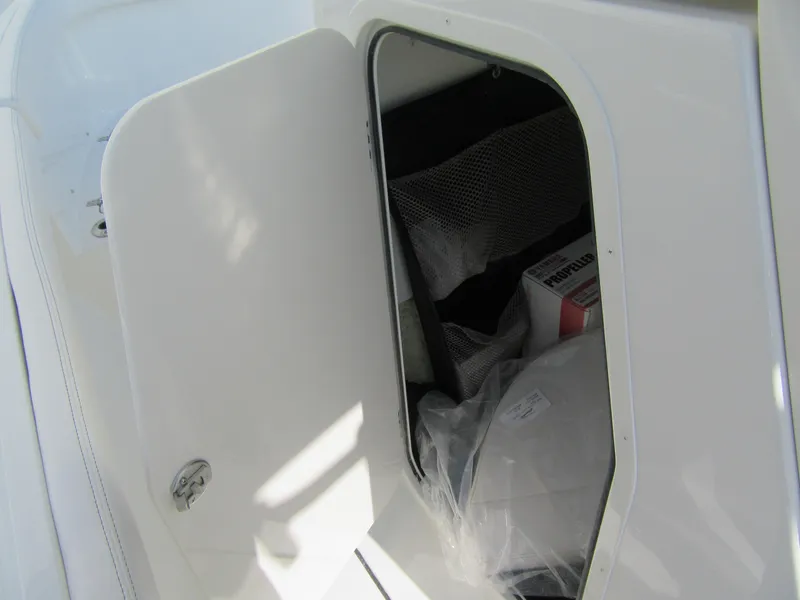 Slide: The Image of Storage compartment of 2025 Parker 2200 Center Console boat, open with visible contents. - 10