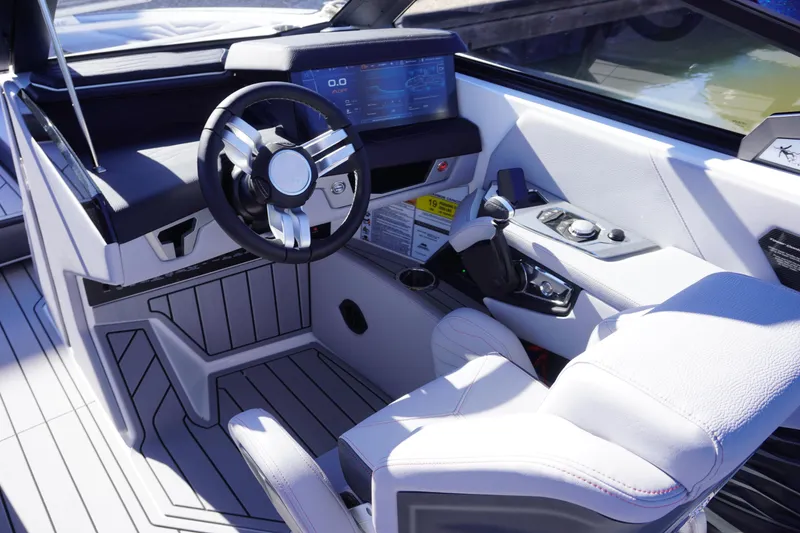 Slide: The Image of 2025 Nautique Super Air Nautique G25 cockpit with modern steering and digital display. - 7