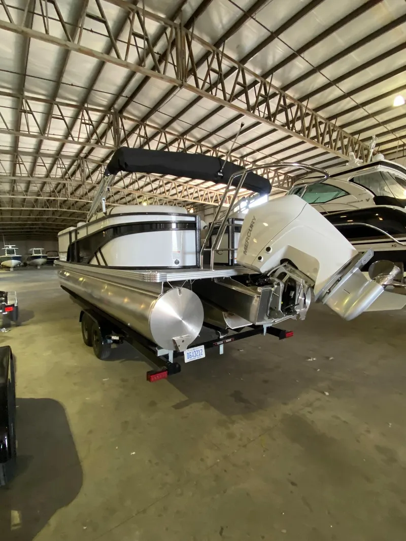 Slide: The Image of 2023 Crest Classic DLX 240 pontoon boat in a storage facility. - 10