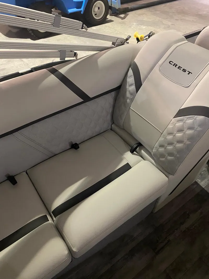Slide: The Image of 2023 Crest Classic DLX 240 boat interior with plush seating and elegant design. - 12