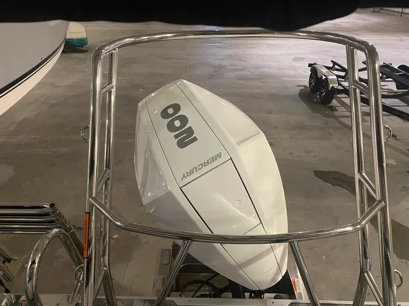 Slide: The Image of 2023 Crest Classic DLX 240 with Mercury 100 outboard motor in a showroom. - 14