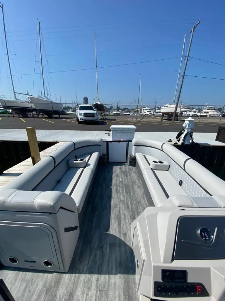 Slide: The Image of 2023 Crest Classic DLX 240 pontoon boat interior with spacious seating and modern design. - 4