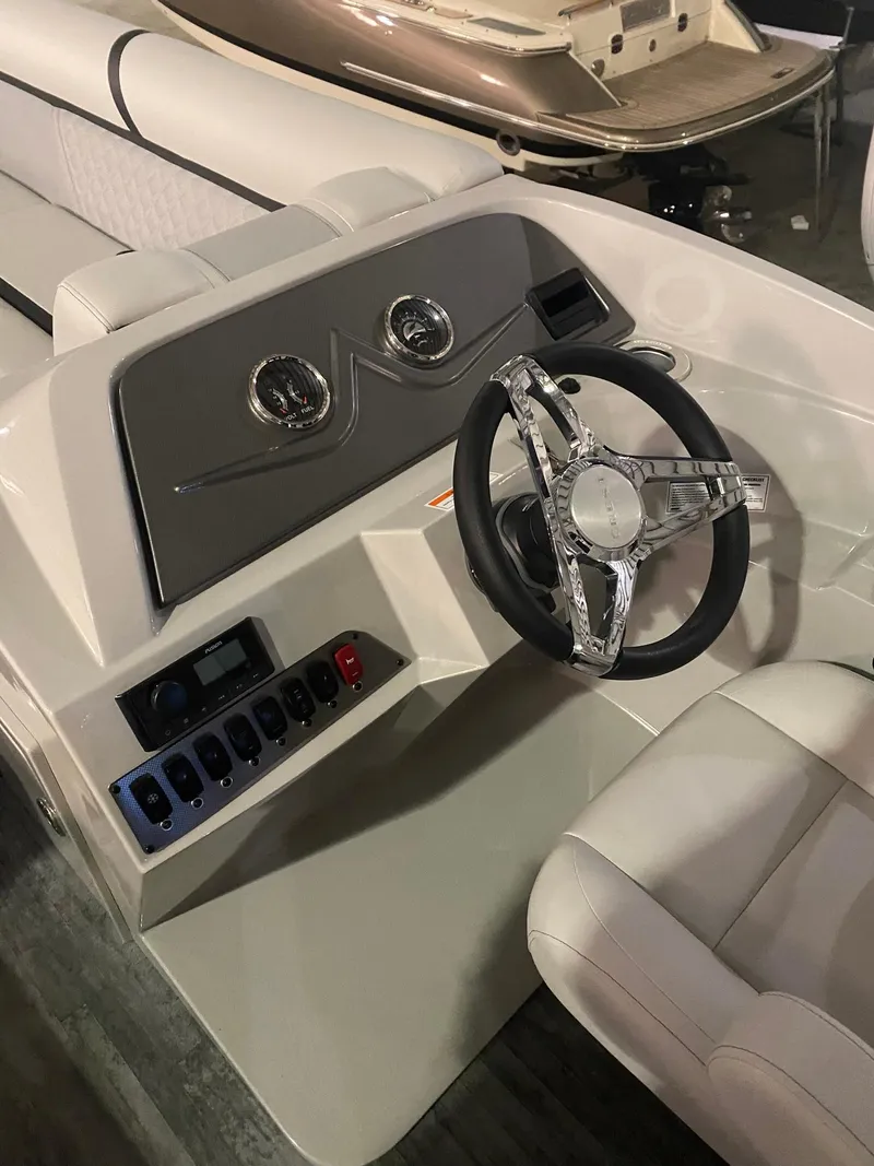 Slide: The Image of 2023 Crest Classic DLX 240 boat interior with steering wheel and control panel. - 7