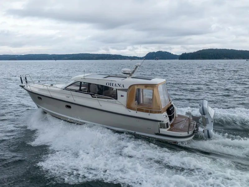 Slide: The Image of Nimbus 365 Coupe 2019 cruising on a lake with scenic forested background. - 2