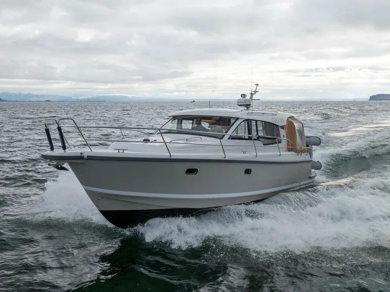Slide: The Image of 2019 Nimbus 365 Coupe cruising on open water under cloudy skies. - 3