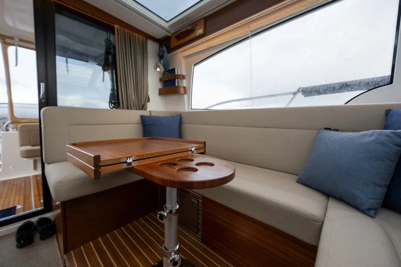 Slide: The Image of Interior of 2019 Nimbus 365 Coupe with cozy seating and wooden table. - 9