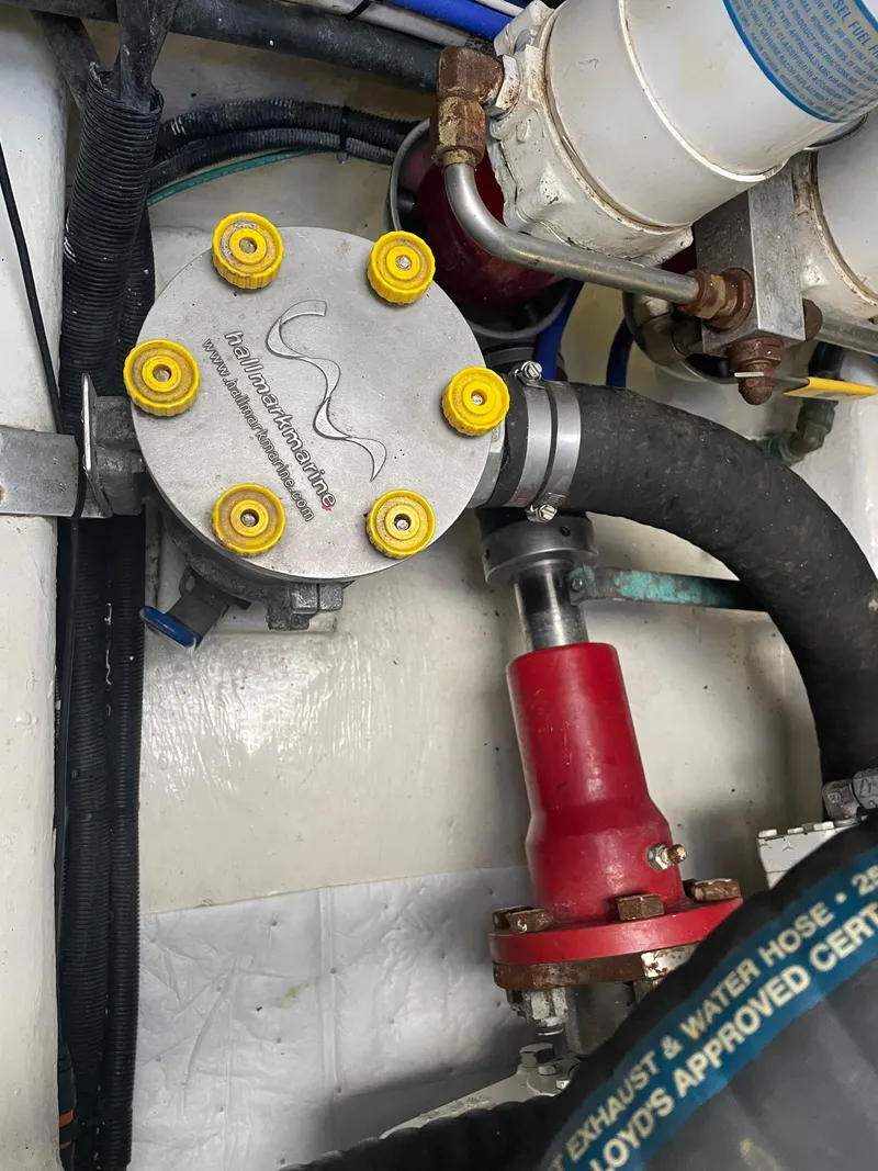 Slide: The Image of Engine compartment of a 2005 Riviera 47 Open Flybridge Series II, showing mechanical components and hoses. - 11