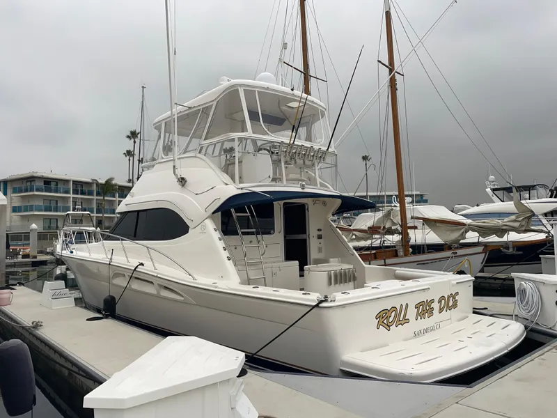 Slide: The Image of 2005 Riviera 47 Open Flybridge Series II yacht docked at marina. - 15