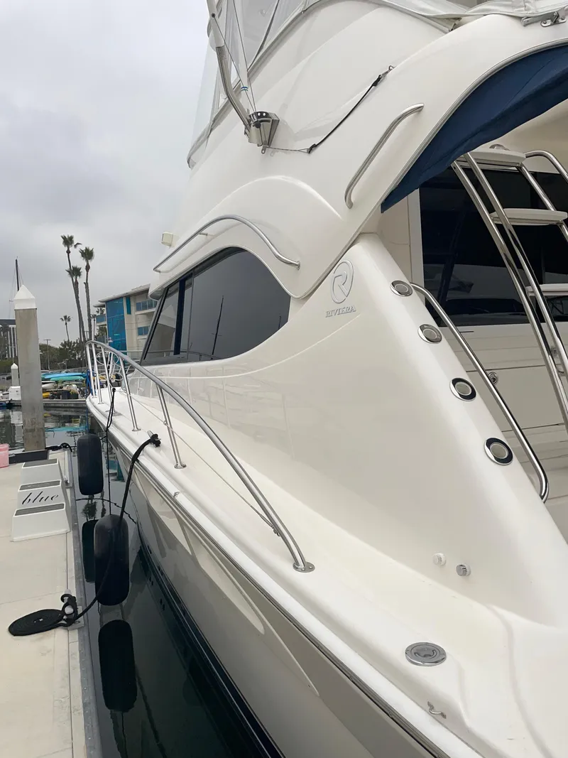 Slide: The Image of 2005 Riviera 47 Open Flybridge Series II yacht docked at marina. - 23