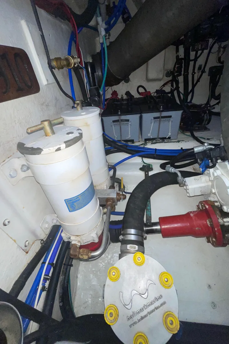 Slide: The Image of Engine room of 2005 Riviera 47 Open Flybridge Series II with visible filters and hoses. - 24