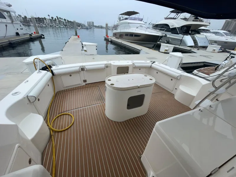 Slide: The Image of 2005 Riviera 47 Open Flybridge Series II yacht docked at marina, spacious deck view. - 25
