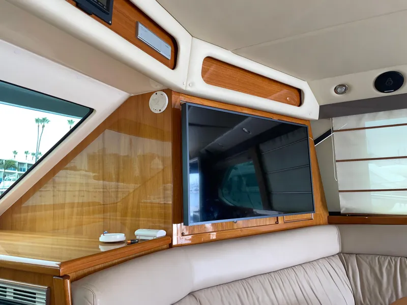Slide: The Image of Interior of 2005 Riviera 47 Open Flybridge Series II with TV and wood paneling. - 26