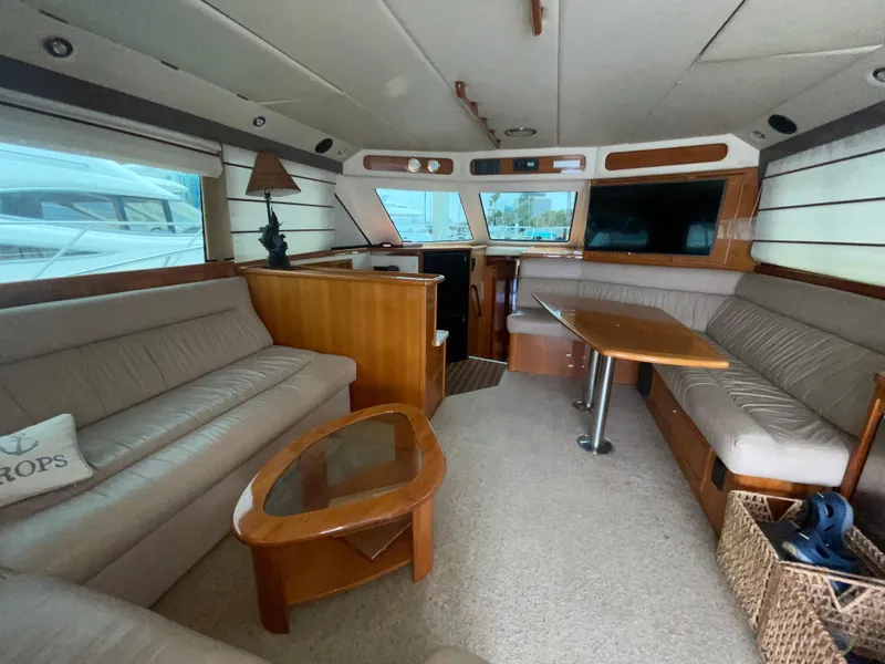 Slide: The Image of Luxurious interior of 2005 Riviera 47 Open Flybridge Series II yacht with elegant seating and table. - 27