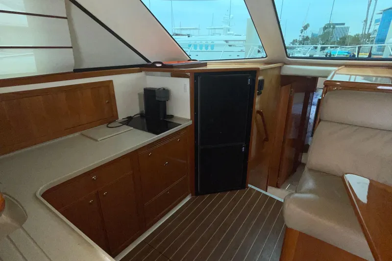 Slide: The Image of Interior of 2005 Riviera 47 Open Flybridge Series II yacht with wood cabinetry and seating. - 35